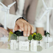 Close-up Of Business People Wind Turbine Model And Houses On Conference Table Art Print