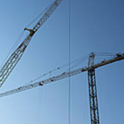 Construction Cranes Against A Blue Sky Art Print