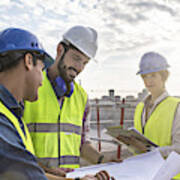 Construction Workers And Architect Looking At Blueprints On Construction Site Art Print