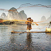 Fisherman On Bamboo Boat Throwing The Art Print