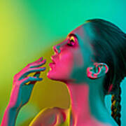 High Fashion Model Woman In Colorful Bright Lights Posing In Studio Art Print