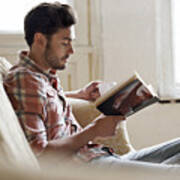 Man Sitting On Sofa Reading Book Art Print