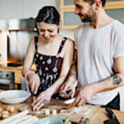 Mature couple preparing food for dinner Art Print