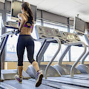 Mid Adult Woman Running On Treadmill In Gym Art Print