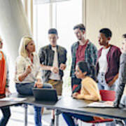 Six College Students Listening To Mature Female Lecturer With Laptop In Classroom Art Print