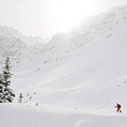 Skier Climbs Snowy Ridge Below Misty Art Print