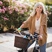 Smiling Senior Woman Having Fun Riding Vintage Bike In Spring Art Print