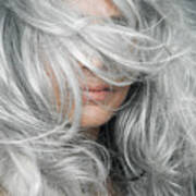 Woman with grey hair blowing across her face. Art Print