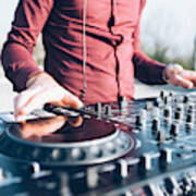 Young Man Using Mixing Desk At Roof Party, Mid Section, Close-up Art Print