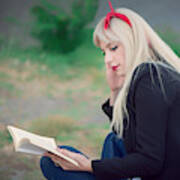 Young Woman Relaxing While Reading A Book At The Park Art Print