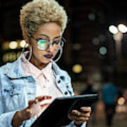 Young Woman Using Tablet At Night Art Print