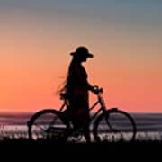 Silhouette Of Girl And Bike At Sunset Near The Sea. Art Print