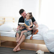 Father And Daugther Play And Read A Book In Bedroom Art Print