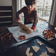 Boy Rolling Cookie Dough On Table During Christmas At Home Art Print