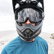 Close-up Of Man Wearing Crash Helmet While Standing On Mountain Against Cloudy Sky Art Print