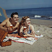Young Couple Lying On Beach With Beer Art Print