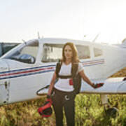 Young Female Skydiver In An Airfield With A Plane Behind Her Art Print