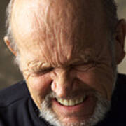 A Wrinkle Faced Balding Elderly Man Wearing A Dark Shirt Scrunches Up His Face While Closing His Eyes And Grimacing Art Print