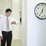 Businessman Checking Watch In Office By Clock Art Print