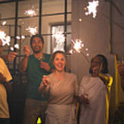 Family And Friends Celebrating New Year Party With Sparkler At Home Art Print