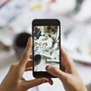 Illustrator's Hands Taking Photo Of Work Desk In Atelier With Smartphone, Close-up Art Print