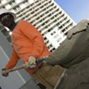 Low Angle View Of A Male Construction Worker Shoveling Cement Art Print