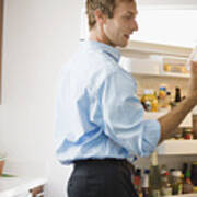 Man Looking At Leftovers In Refrigerator Art Print