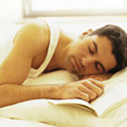 Man Lying Down In Bed With Hand On Book Art Print