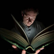 Man Reading Book Illuminated By Light Art Print