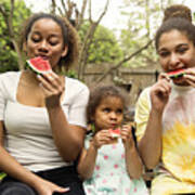 Mixed-race Sisters Eating Watermelon In Backyard. Art Print