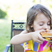 Preschool Girl Eating Messy Cheeseburger On Patio Art Print