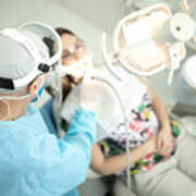 Senior Dentist Examining The Teeth Of A Young Woman Art Print