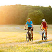 Smiling Sporty Couple On Mountain Bikes In Rural Landscape Art Print