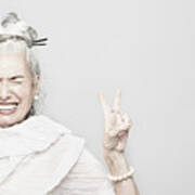 Studio Portrait Of Sophisticated Senior Woman Making Victory Sign Art Print