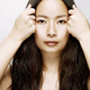 Young Asian Woman Holding Hair Back From Her Face Art Print
