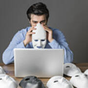 Young Man Holding Mask In Front Of Computer Art Print