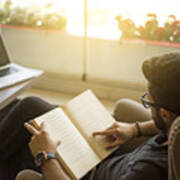 Young Man Reading A Book In A Cafe. Art Print