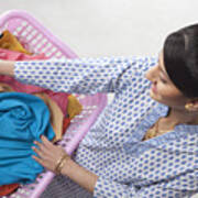 Young Woman Holding A Basket Of Clothes Art Print