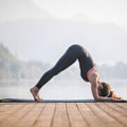 Young Woman In Dolphin Pose On Pier Overlooking Lake Bled Art Print