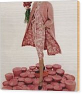 A Model Wearing A Matching Pink Outfit Holding Wood Print