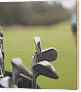 A Set Of Golf Clubs On The Green Wood Print