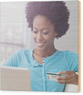 African American Woman Shopping On Laptop With Credit Card On Sofa Wood Print
