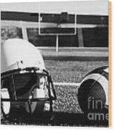 American Football And Helmet On Field Wood Print