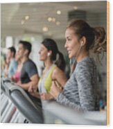 Beautiful Woman Exercising At The Gym Running On A Treadmill Wood Print