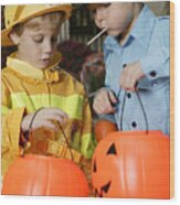 Boys In Halloween Costumes Eating Candy Wood Print