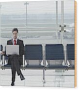 Businessman In Airport With Laptop And Mobile Phone Wood Print