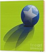 Blue Ball Decorated With Star Green Background Wood Print