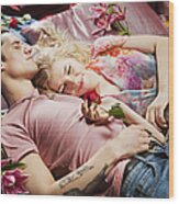 Couple Laying On Bed Surrounded By Flowers. Wood Print