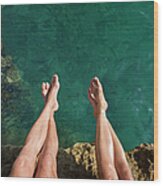 Couples Legs Above Turquoise Ocean Wood Print