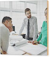 Coworkers Discussing Plans At Table In Office Wood Print